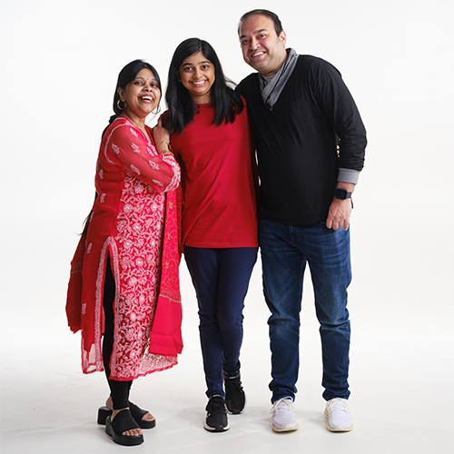 The Banerjee family poses for a family photo.