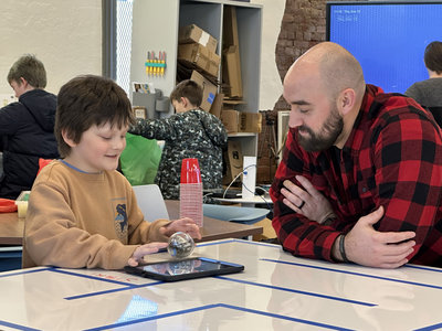 Curiosity was sparked at Fluxspace in Pittsburgh while this student tried to get the ball-robot to complete a maze during Computer Science Week.