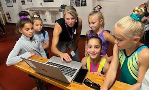 A family mentor mentoring a group of student acrobats